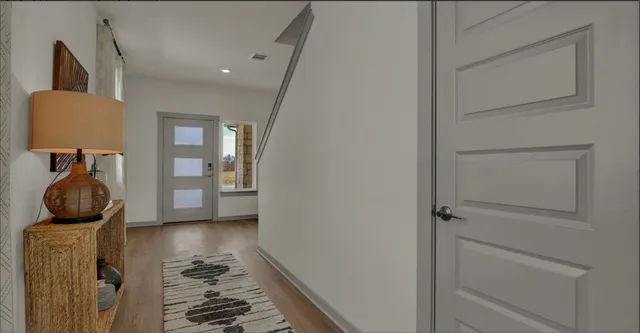 a view of hallway with livingroom and furniture