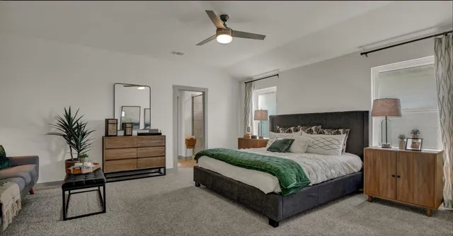 a large bedroom with a bed and a chandelier