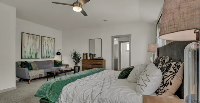 a bedroom with bed and a couch