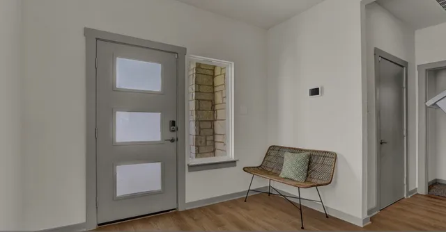 a view of a livingroom with furniture and a window