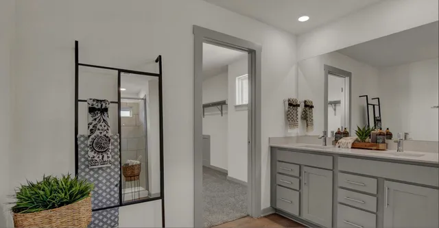 a bathroom with a shower sink and mirror