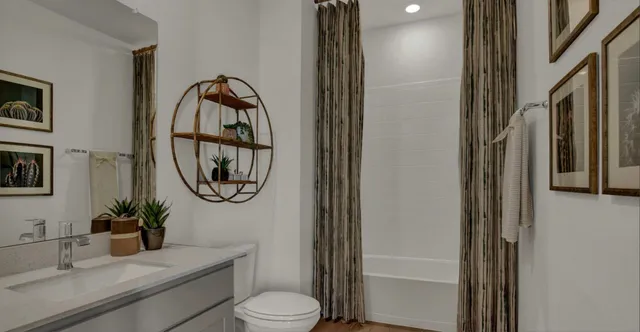 a bathroom with a toilet a sink and a mirror
