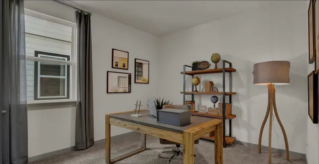 a view of a workspace with furniture