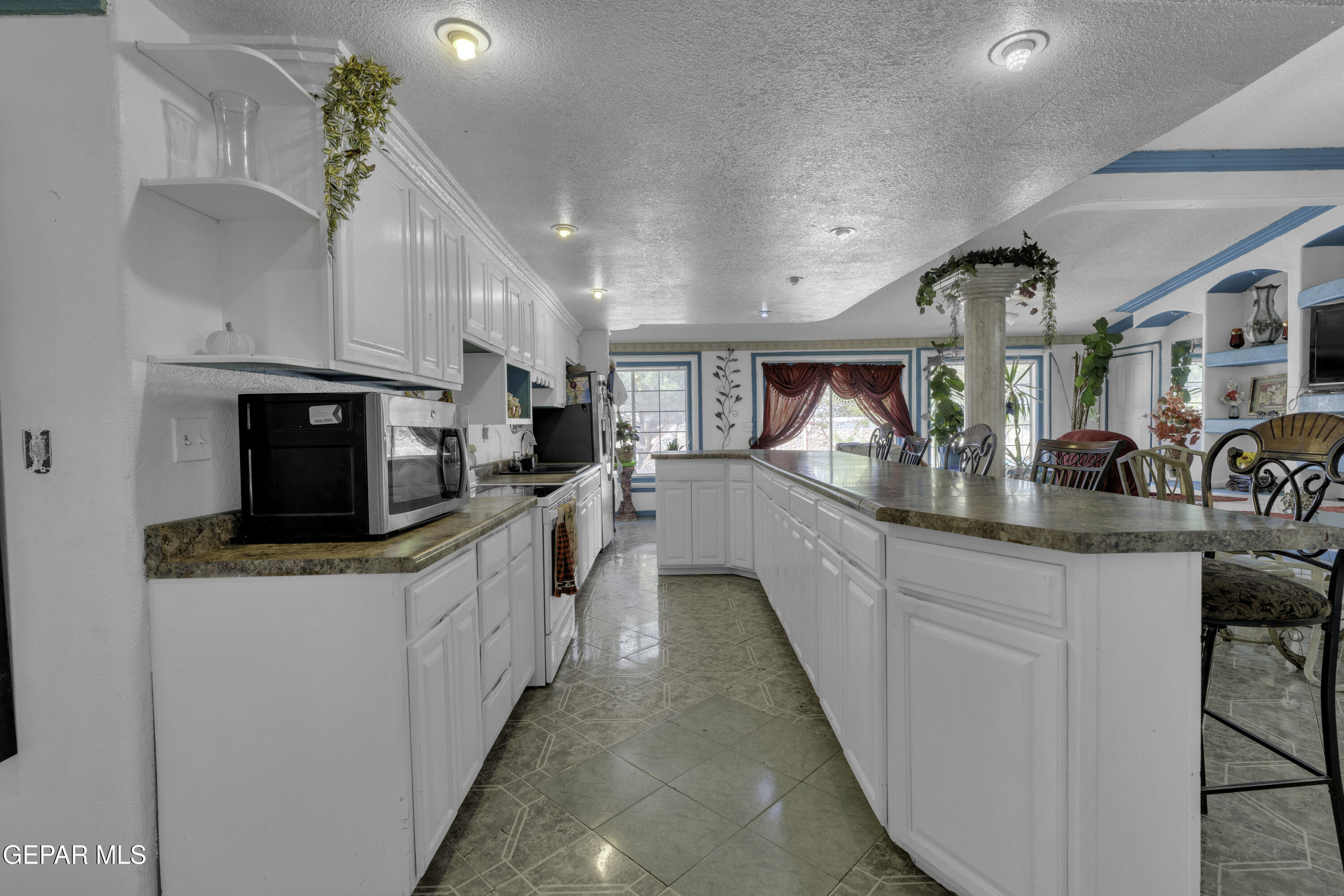 15931 Harrison Road El Paso, TX 79928 - Photo 27 of 83 a large kitchen with stainless steel appliances kitchen island granite countertop a sink and cabinets
