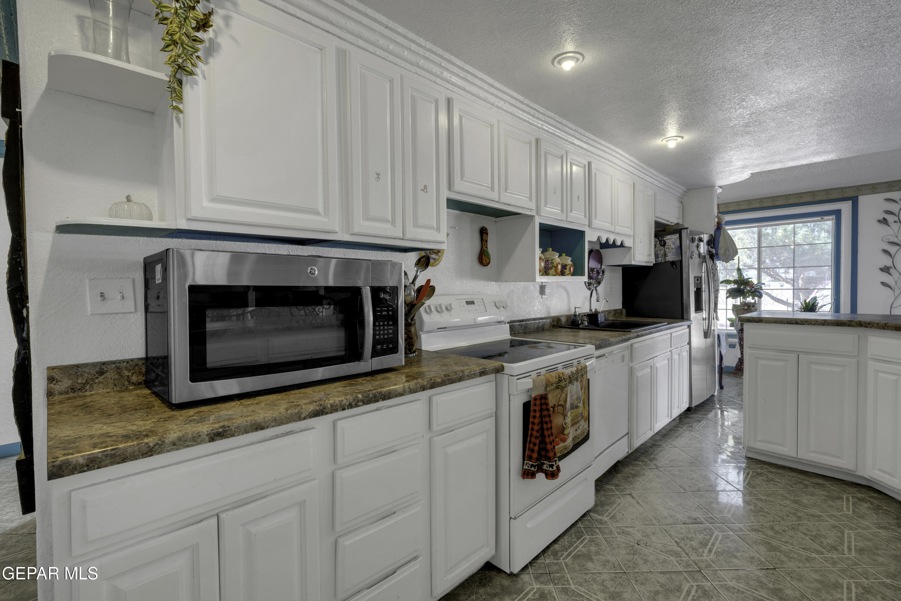 15931 Harrison Road El Paso, TX 79928 - Photo 29 of 83 a kitchen with stainless steel appliances granite countertop a stove a sink and a microwave