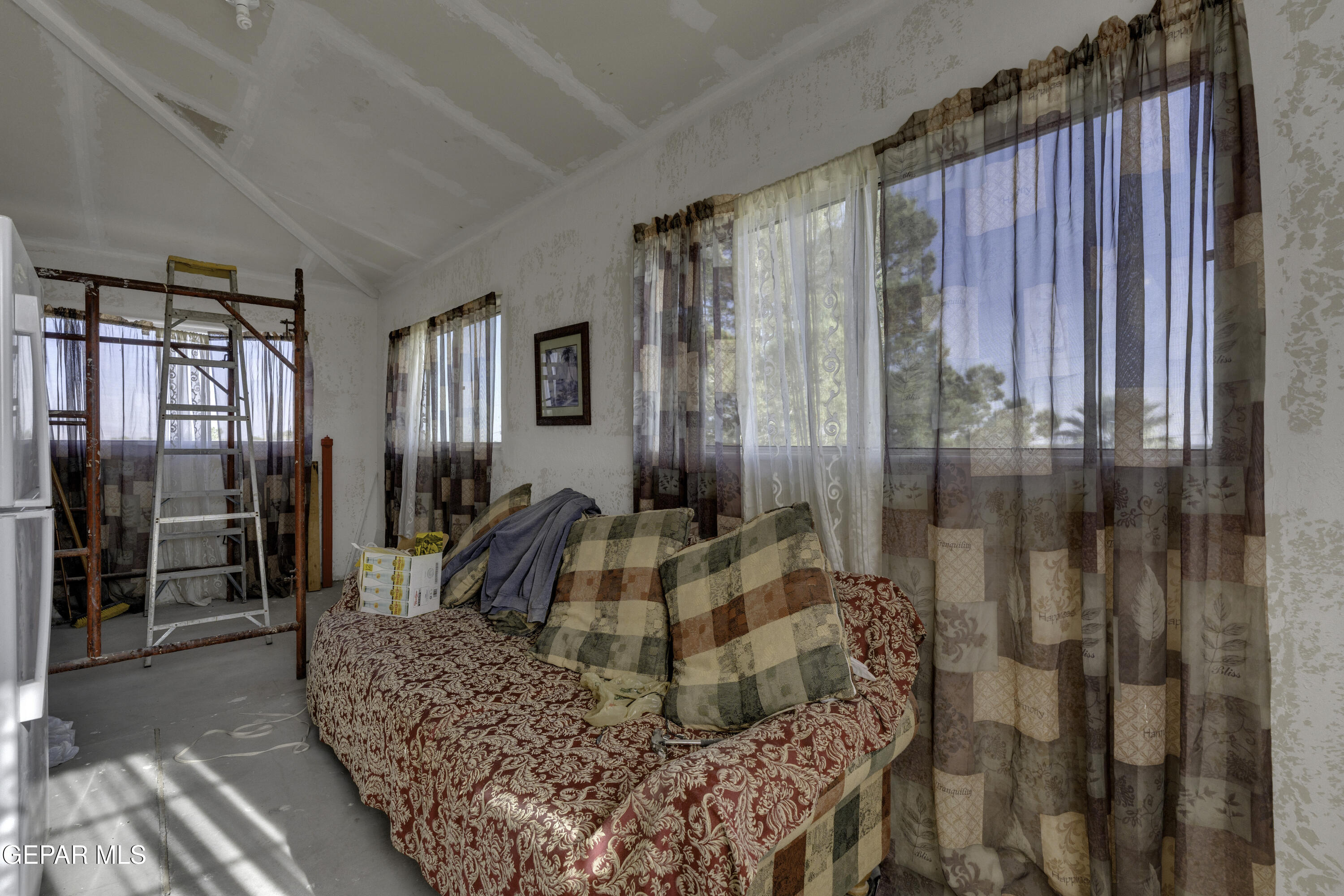 15931 Harrison Road El Paso, TX 79928 - Photo 59 of 83 a living room with furniture a large window and a rug