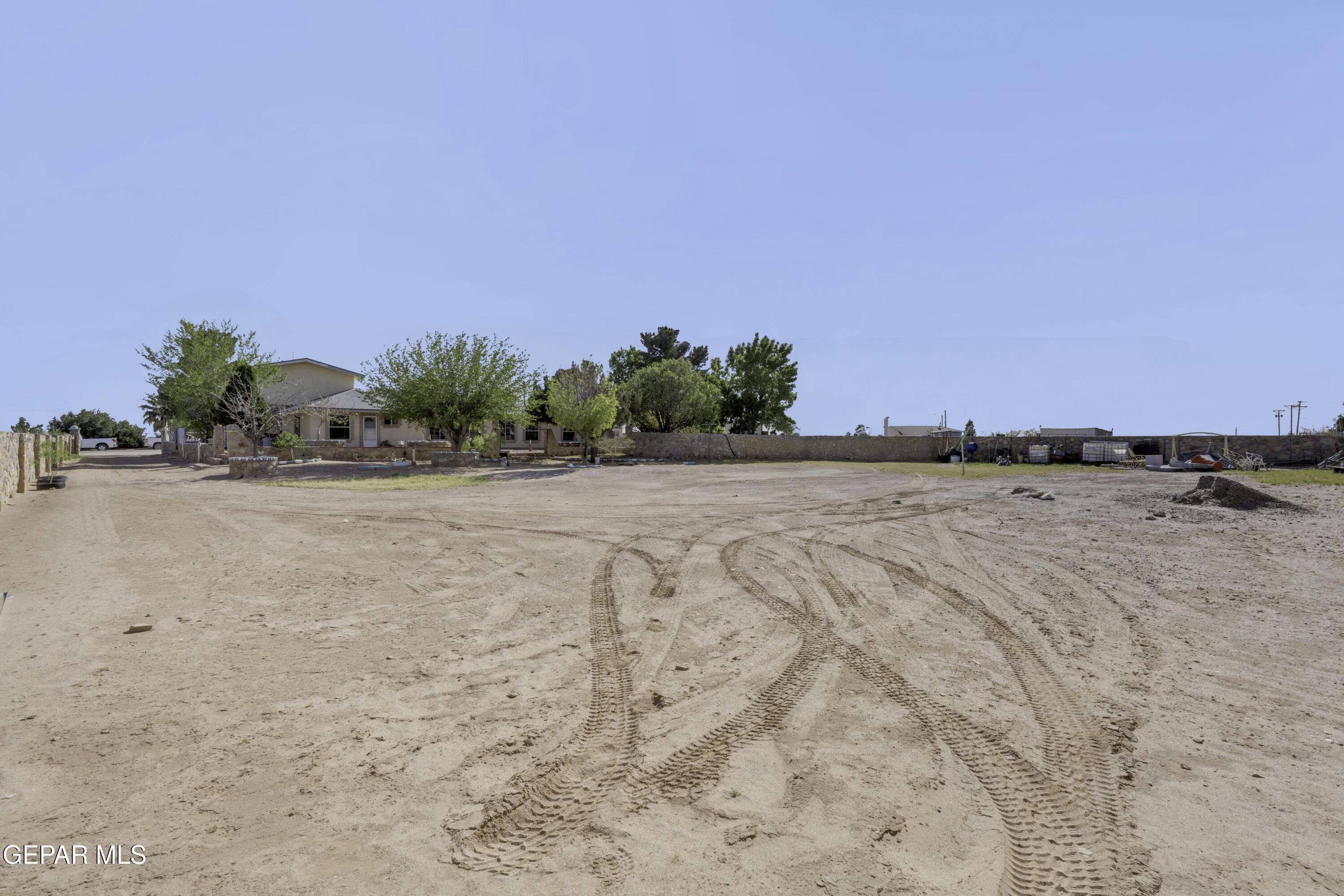 15931 Harrison Road El Paso, TX 79928 - Photo 73 of 83 a view of dirt field with trees in background