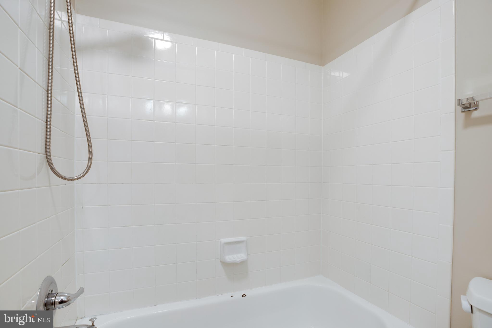 6502 Westhaven Lane Springfield, VA 22150 - Photo 18 of 31 a bathroom with a bath tub and a shower