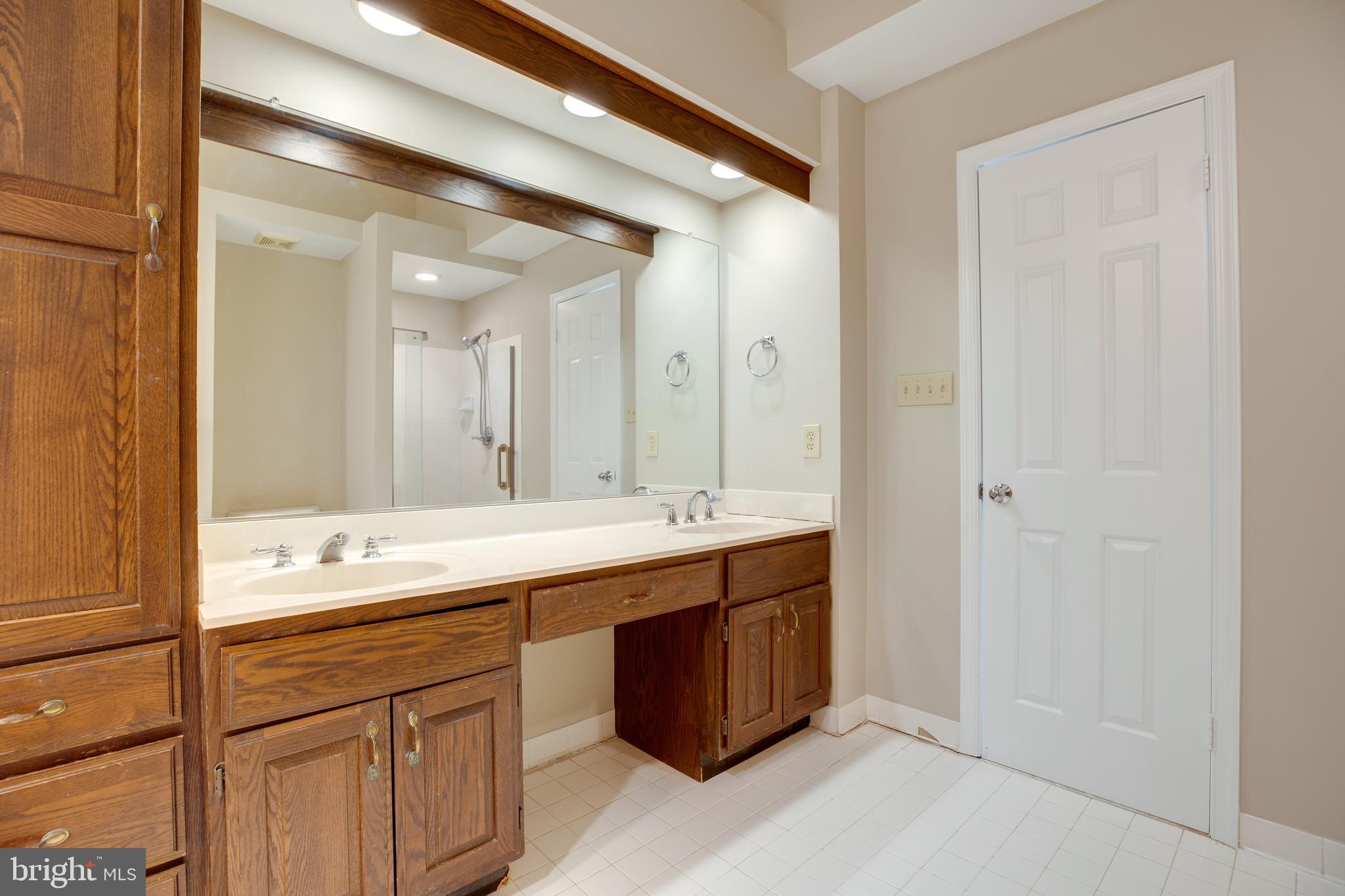 6502 Westhaven Lane Springfield, VA 22150 - Photo 22 of 31 a bathroom with a double vanity sink and mirror