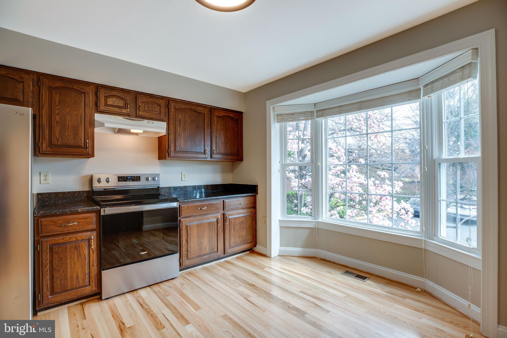 6502 Westhaven Lane Springfield, VA 22150 - Photo 5 of 31 a kitchen with stainless steel appliances granite countertop a stove a sink and a microwave