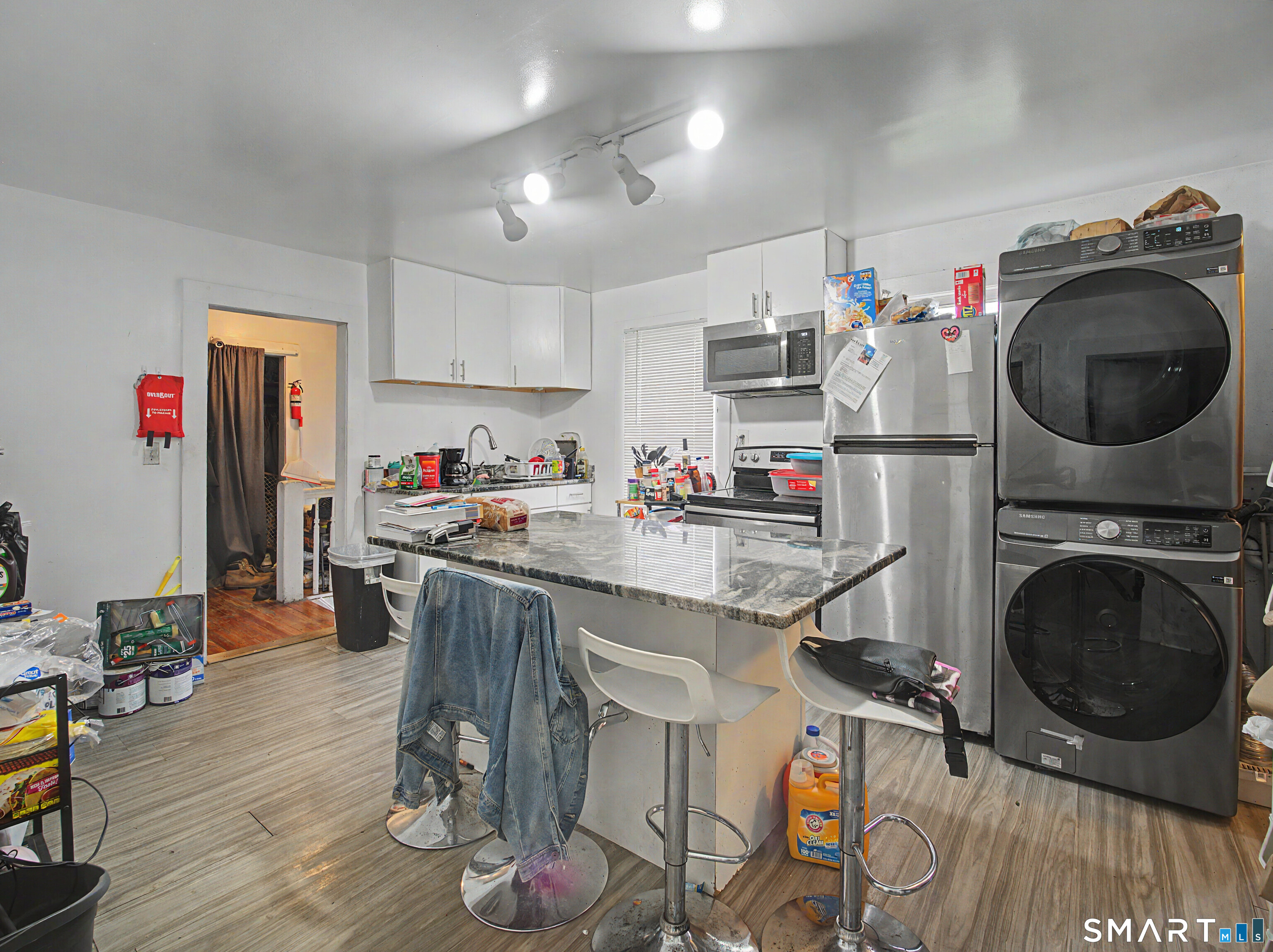 319 Carroll Avenue Bridgeport, CT 06607 - Photo 23 of 40 a kitchen with granite countertop a sink a stove and wooden floor