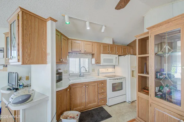 a kitchen with stainless steel appliances granite countertop a sink a stove and a refrigerator