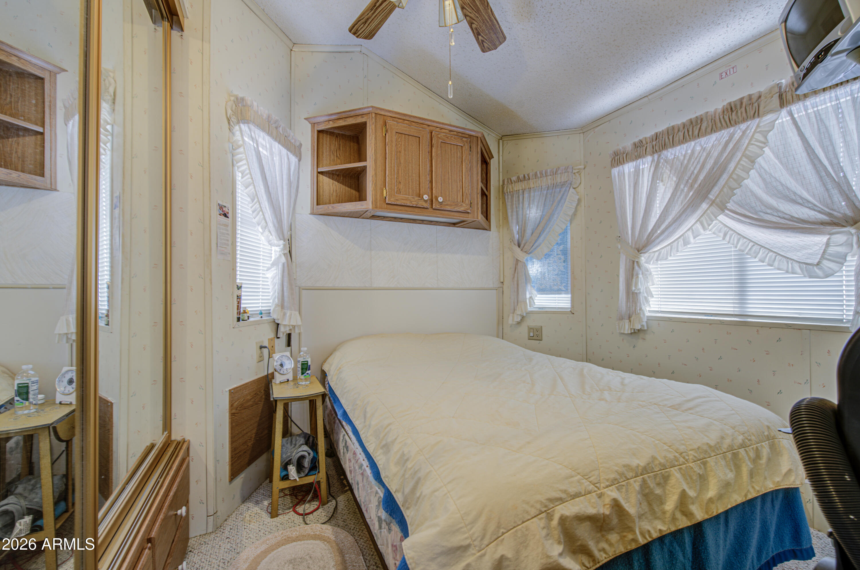 111 South Greenfield Road, Unit 747 Mesa, AZ 85206 - Photo 15 of 23 a bedroom with a bed and a dresser with windows