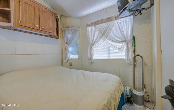 a bedroom with a bed and a window