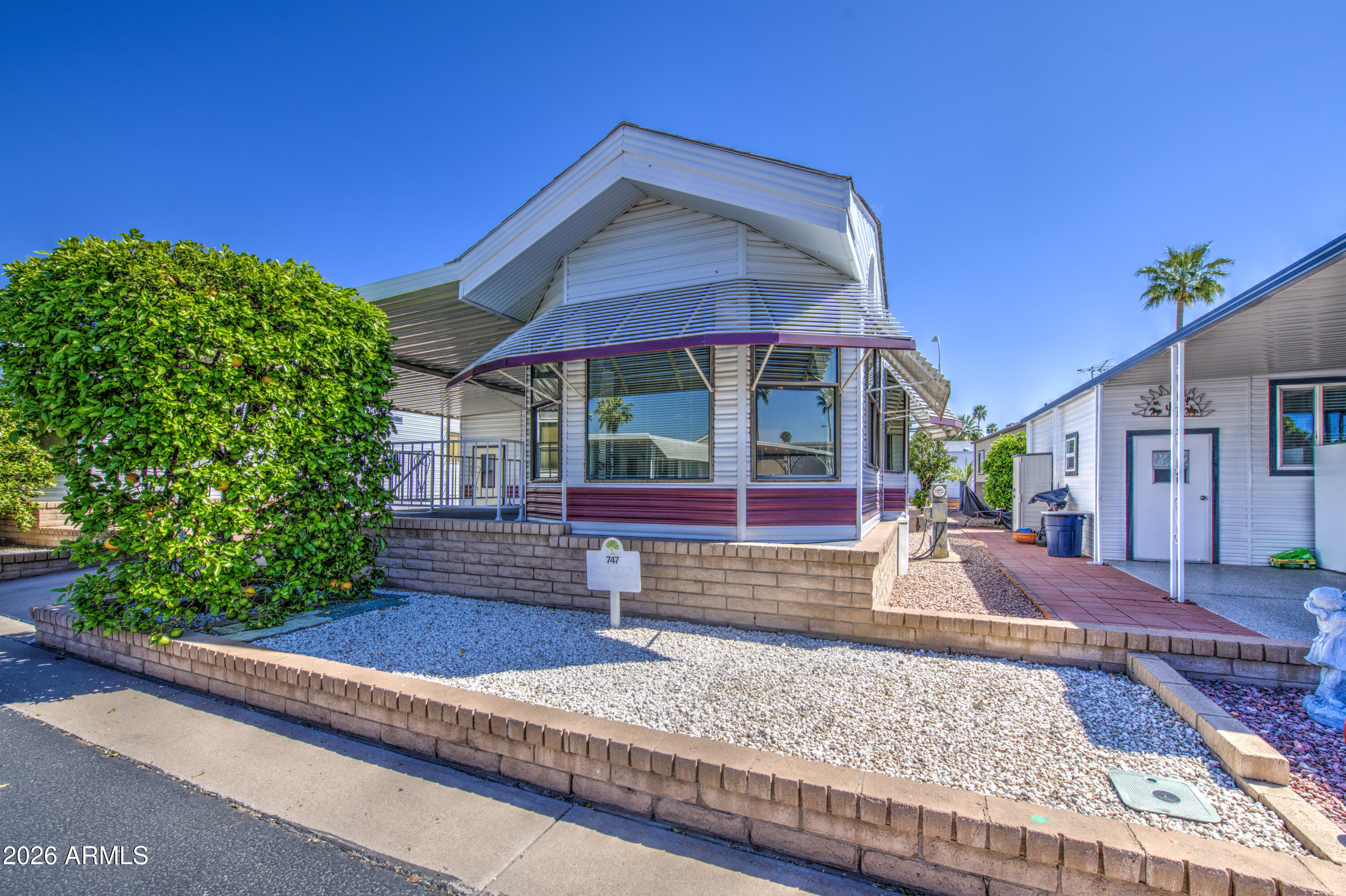 111 South Greenfield Road, Unit 747 Mesa, AZ 85206 - Photo 2 of 23 a view of a house with a yard