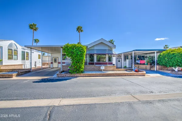 a view of a house with a yard and potted plants