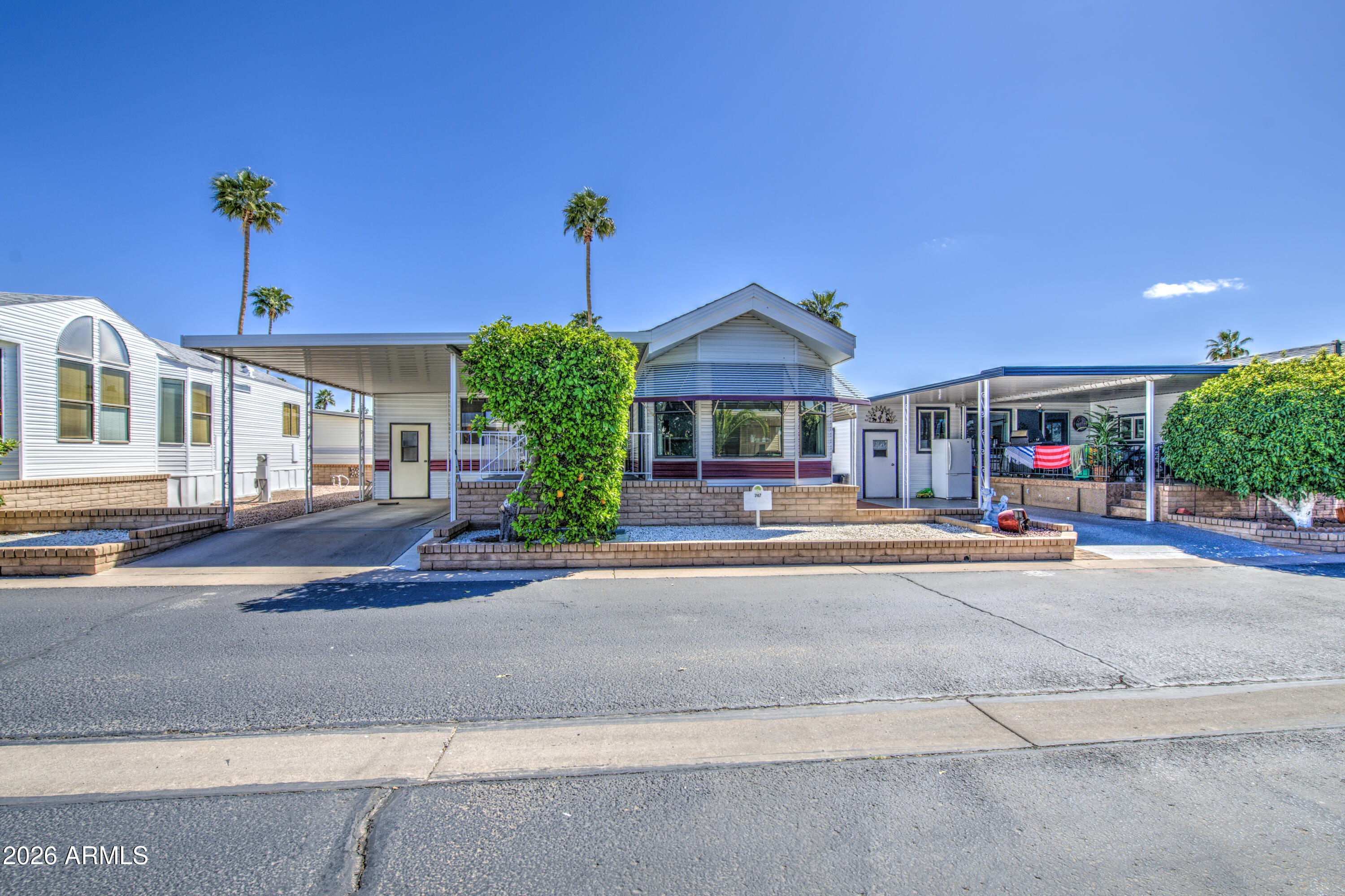 111 South Greenfield Road, Unit 747 Mesa, AZ 85206 - Photo 3 of 23 a view of a house with a yard and potted plants