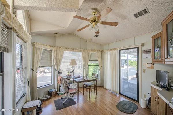 a view of a livingroom with furniture hardwood floor and a ceiling fan