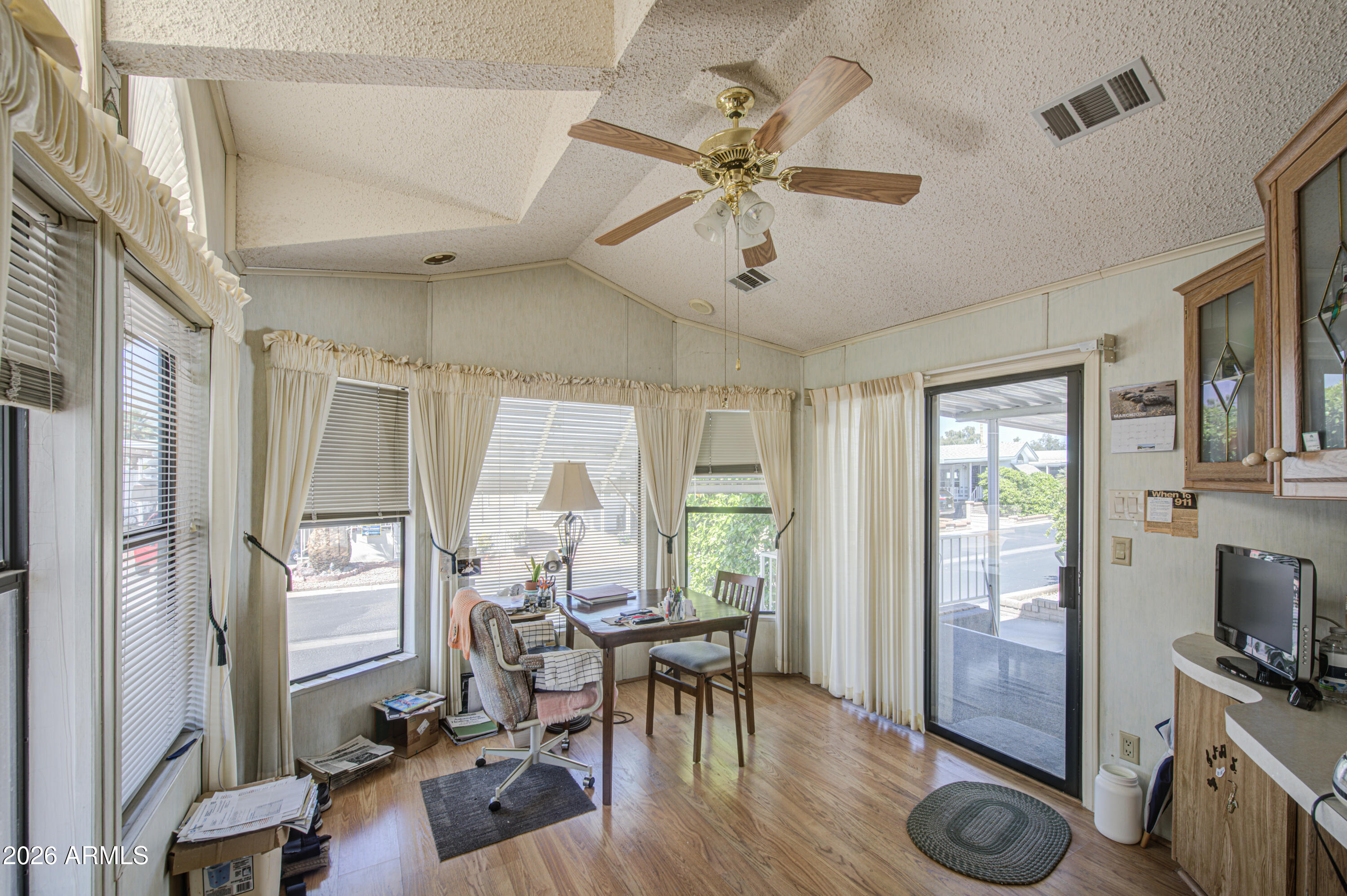 111 South Greenfield Road, Unit 747 Mesa, AZ 85206 - Photo 7 of 23 a view of a livingroom with furniture hardwood floor and a ceiling fan