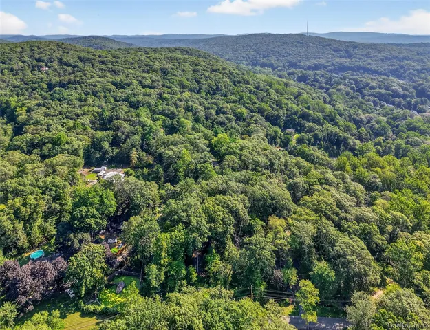 a view of a green field with lots of bushes