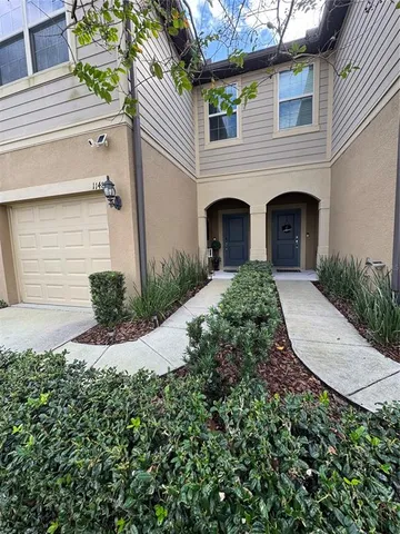 a view of a house with a small yard