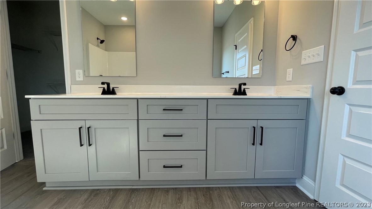 7697 Rufus Johnson Road Fayetteville, NC 28306 - Photo 12 of 16 a bathroom with a sink vanity and mirror