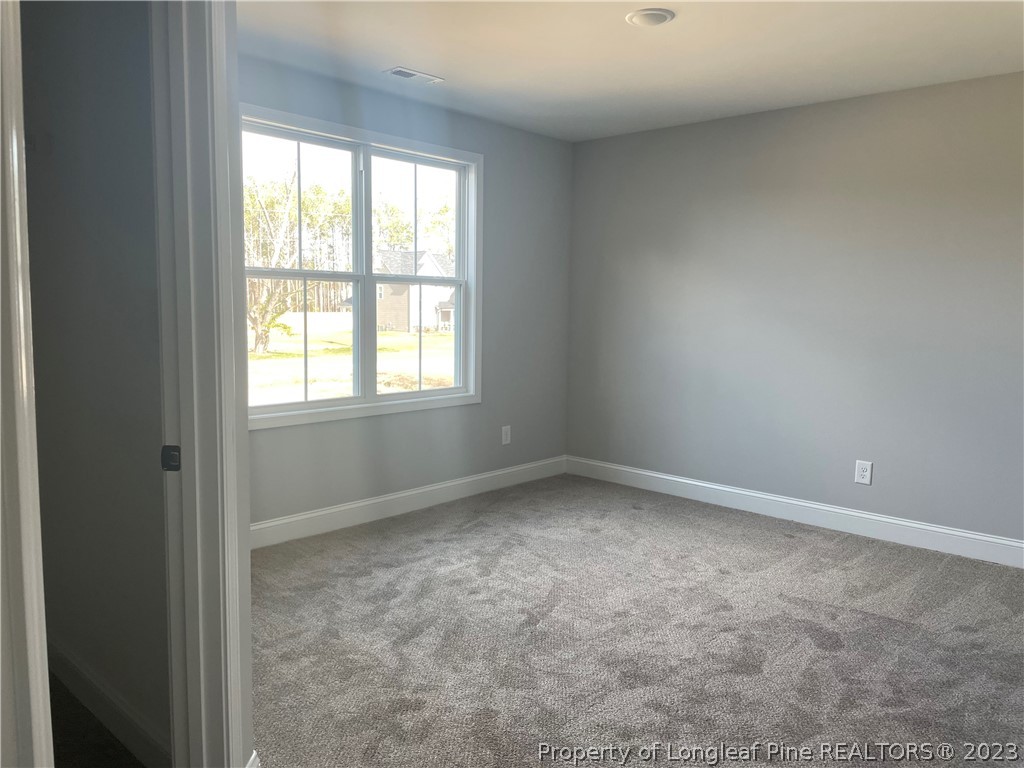 7697 Rufus Johnson Road Fayetteville, NC 28306 - Photo 13 of 16 an empty room with a window
