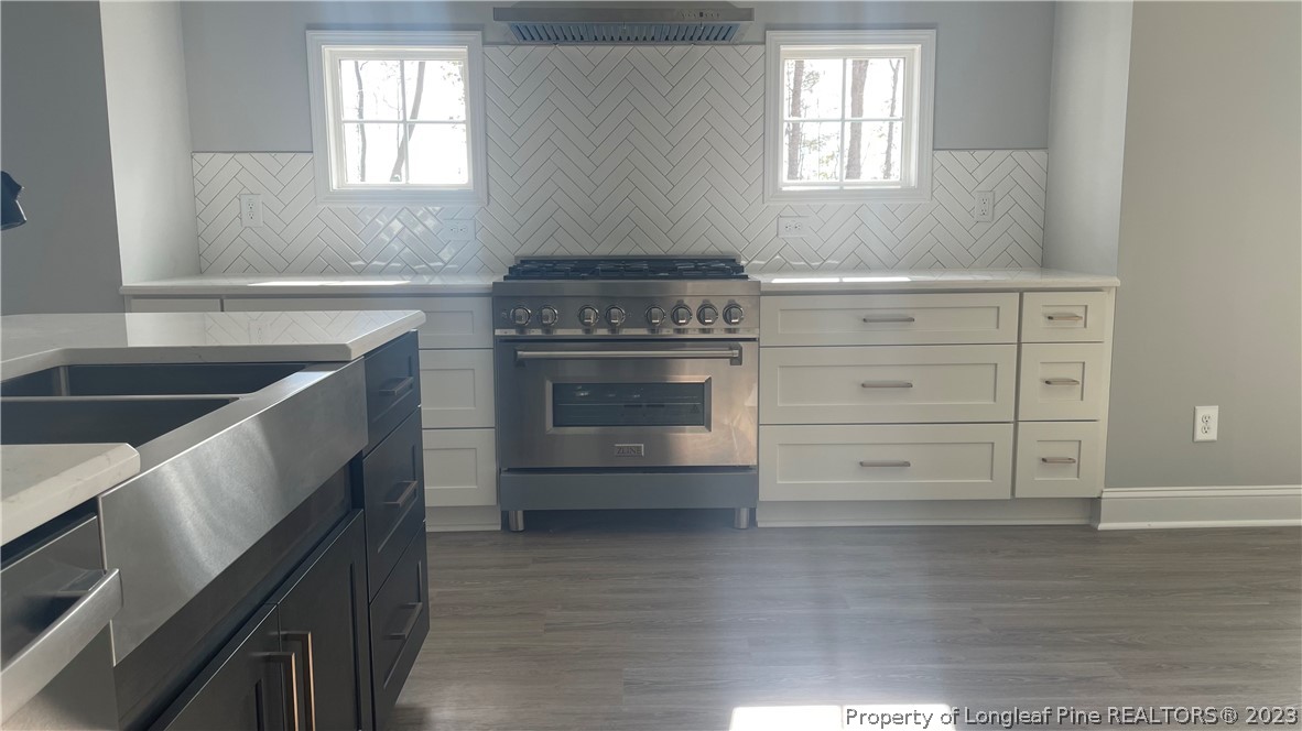 7697 Rufus Johnson Road Fayetteville, NC 28306 - Photo 5 of 16 a kitchen with a stove and a sink