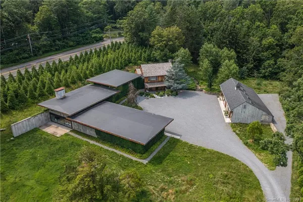 an aerial view of a house with yard and outdoor seating