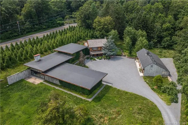 an aerial view of a house with yard and outdoor seating