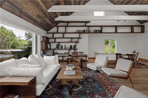 a dining hall with stainless steel appliances granite countertop a stove and a refrigerator