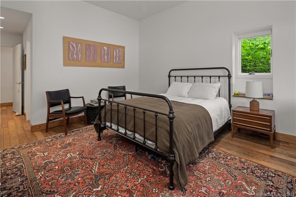 4 Good Hill Road Weston, CT 06883 - Photo 21 of 40 a bedroom with a bed and a chair