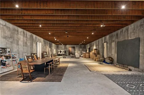 a room with gym equipment and a chandelier