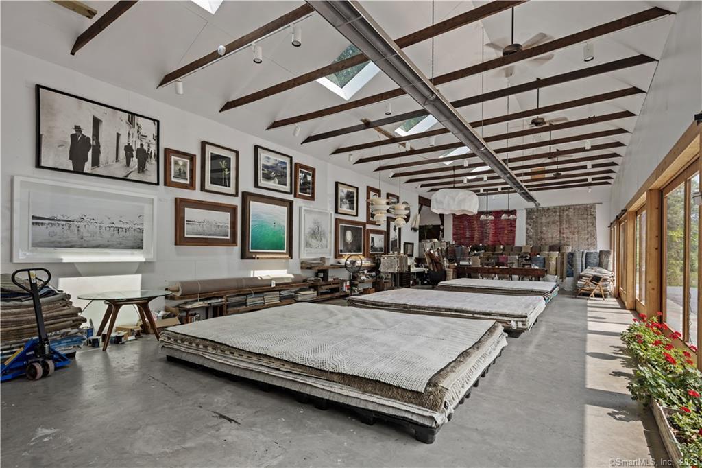 4 Good Hill Road Weston, CT 06883 - Photo 38 of 40 a room with gym equipment and a chandelier