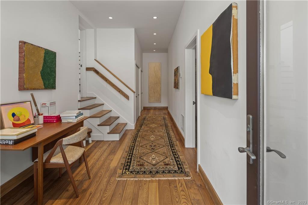 4 Good Hill Road Weston, CT 06883 - Photo 7 of 40 a view of a hallway with wooden floor and furniture