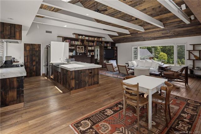 a living room with lots of furniture and kitchen view