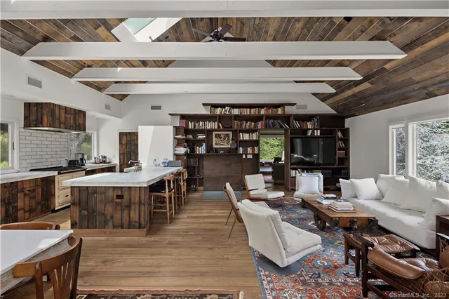 a living room with furniture and a floor to ceiling window