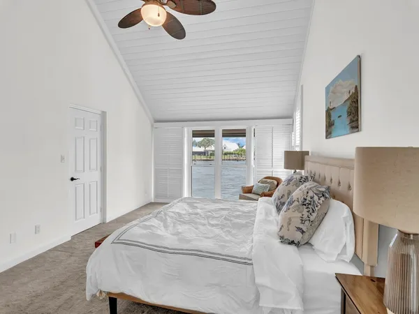 a bedroom with a bed and a large mirror