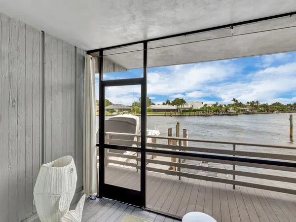 a view of a balcony with furniture and city view