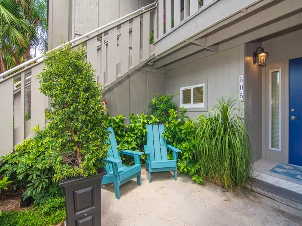 a view of a house with potted plants