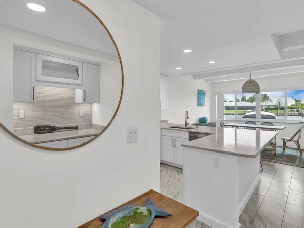 a view of kitchen with sink and refrigerator