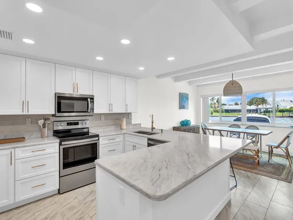 a kitchen with stainless steel appliances granite countertop a stove and a sink