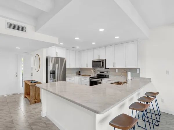 a kitchen with stainless steel appliances a refrigerator and a sink
