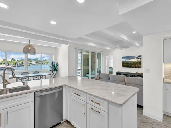 a kitchen with a sink and living room