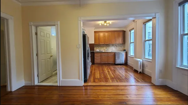 a view of kitchen and bathroom with wooden floor