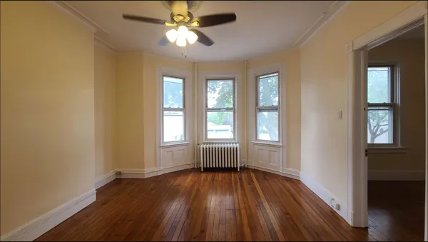 wooden floor in an empty room with a window