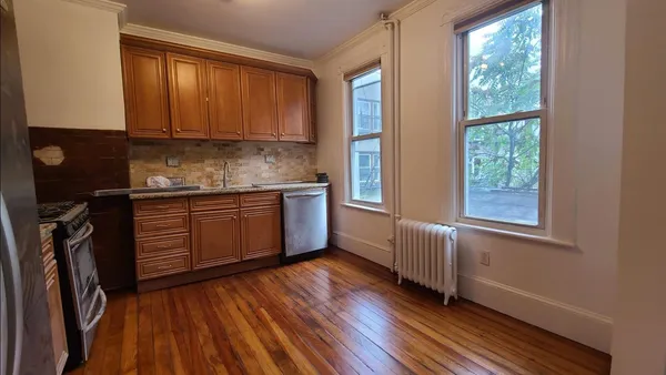 a kitchen with granite countertop wooden floors and sink