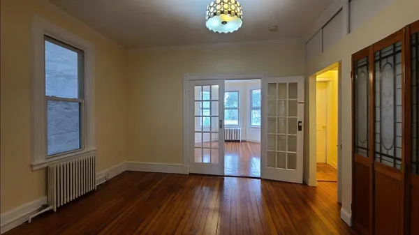 wooden floor in an empty room with a window