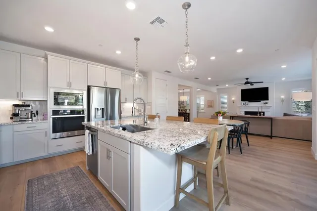 a spacious bedroom with a bed and a chandelier