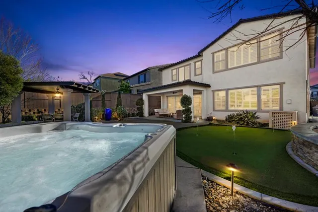 a view of a dining room with furniture wooden floor and chandelier